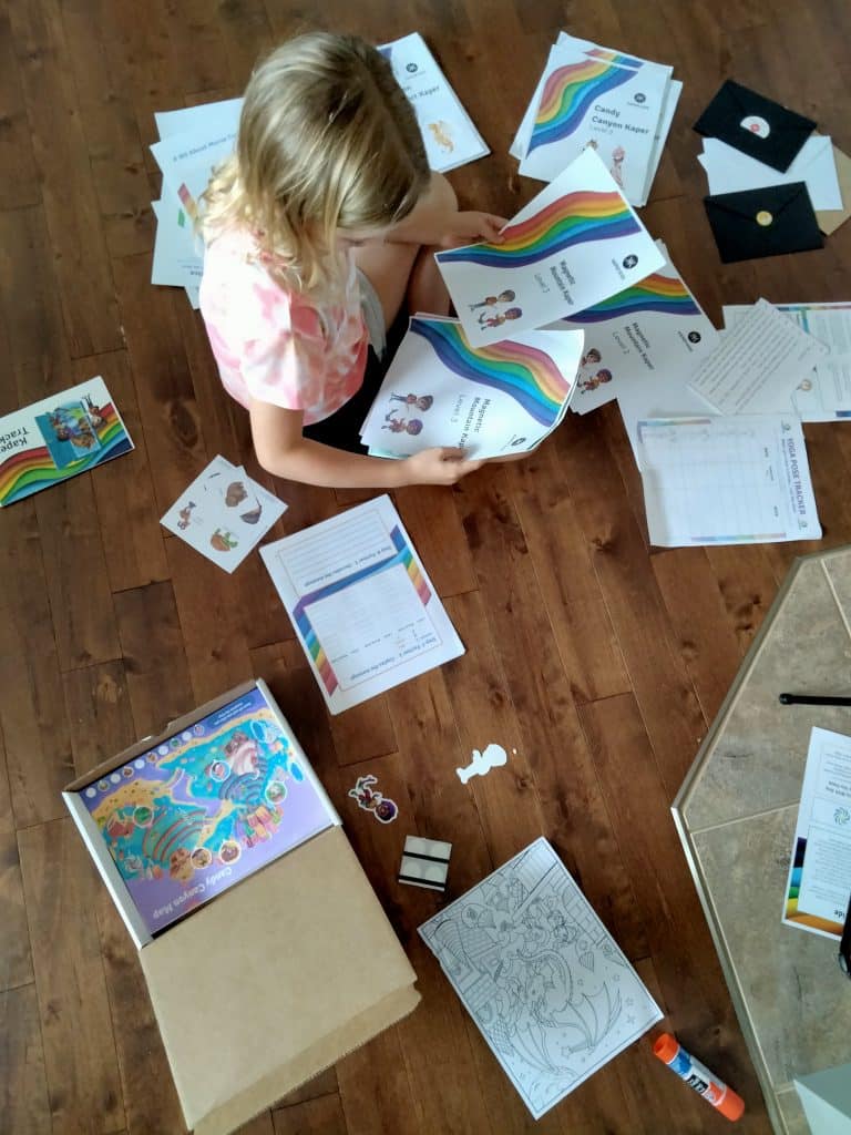 A child opening her Kaper Kit excitedly